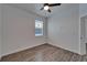 A bright bedroom enhanced by a ceiling fan and luxury vinyl plank flooring at 6097 Vermont Ave, New Port Richey, FL 34653