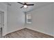 A bright bedroom enhanced by a ceiling fan and luxury vinyl plank flooring at 6097 Vermont Ave, New Port Richey, FL 34653