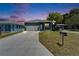 Charming one-story home with a well-manicured lawn and long driveway, inviting curb appeal at 6097 Vermont Ave, New Port Richey, FL 34653