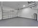 Oversized garage features a painted floor, utility hookups, and garage door at 6097 Vermont Ave, New Port Richey, FL 34653