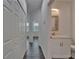Bright hallway with white trim, wood flooring, with bath and bedrooms nearby at 6097 Vermont Ave, New Port Richey, FL 34653