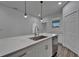 Kitchen featuring stainless steel appliances, granite countertops, a center island, and a view to the backyard at 6097 Vermont Ave, New Port Richey, FL 34653