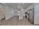 Bright kitchen with white cabinets, stainless steel appliances, an island, and modern finishes with plenty of counter space at 6097 Vermont Ave, New Port Richey, FL 34653