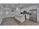 Well-lit kitchen boasts stainless steel appliances, a center island with pendant lights, and modern finishes at 6097 Vermont Ave, New Port Richey, FL 34653