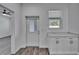 Bright kitchen featuring white cabinets, granite countertops, modern fixtures, and access to the backyard at 6097 Vermont Ave, New Port Richey, FL 34653