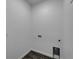 A practical laundry room offers essential utility connections and durable, stylish flooring at 6097 Vermont Ave, New Port Richey, FL 34653