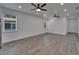 Bright living room featuring wood floors, recessed lights, and a large window, ideal for relaxation at 6097 Vermont Ave, New Port Richey, FL 34653