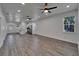 Open-concept living room with wood flooring, recessed lighting, and modern ceiling fans, perfect for entertaining at 6097 Vermont Ave, New Port Richey, FL 34653