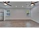 Open living area with hardwood floors, recessed lighting, and large windows, offering natural light at 6097 Vermont Ave, New Port Richey, FL 34653