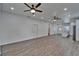 Spacious living room with hardwood floors, ceiling fans, and white walls, creating a bright and airy atmosphere at 6097 Vermont Ave, New Port Richey, FL 34653