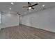 Expansive living room with wood floors, ample lighting, and multiple entryways, seamlessly connecting spaces at 6097 Vermont Ave, New Port Richey, FL 34653