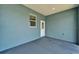 Clean covered patio overlooking a fenced backyard at 6097 Vermont Ave, New Port Richey, FL 34653