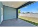 Covered patio with a door overlooking a lush, fenced backyard with a well-manicured lawn at 6097 Vermont Ave, New Port Richey, FL 34653