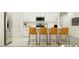 This modern kitchen design features a kitchen island with seating and stainless steel appliances at 6517 Propel Run, New Port Richey, FL 34655
