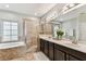 Bathroom with double sink vanity and tiled walk-in shower at 7705 S Sparkman St, Tampa, FL 33616