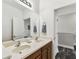 Bathroom with double vanity sinks, wood cabinets, and neutral wall paint for a clean and modern look at 7705 S Sparkman St, Tampa, FL 33616