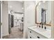 Stylish half bathroom featuring white marble counter, custom mirror, and shiplap accents at 7705 S Sparkman St, Tampa, FL 33616