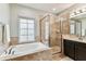 Bathroom with soaking tub and tiled walk-in shower at 7705 S Sparkman St, Tampa, FL 33616