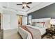 Bedroom with king bed, ceiling fan, and sliding barn door to bathroom at 7705 S Sparkman St, Tampa, FL 33616