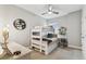 bedroom featuring a bunk bed, ceiling fan, and decorative wall accents at 7705 S Sparkman St, Tampa, FL 33616