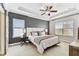 Bedroom with gray accent wall, ceiling fan, and sliding door at 7705 S Sparkman St, Tampa, FL 33616