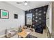 Charming ' bedroom featuring airplane wallpaper, storage shelves, and a cozy sitting area at 7705 S Sparkman St, Tampa, FL 33616