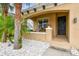 A welcoming front porch with white rocks, palm trees, flowers, and a decorated front door at 7705 S Sparkman St, Tampa, FL 33616