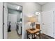 Hallway connecting the laundry room and bathroom featuring updated flooring and modern doors at 7705 S Sparkman St, Tampa, FL 33616