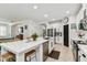 Bright open-concept kitchen featuring stainless steel appliances, a large island and barstool seating at 7705 S Sparkman St, Tampa, FL 33616