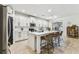 Spacious kitchen featuring an island with seating, white cabinetry, and stainless steel appliances at 7705 S Sparkman St, Tampa, FL 33616