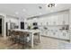 Spacious kitchen with large island, white cabinetry, stainless steel appliances and barstool seating at 7705 S Sparkman St, Tampa, FL 33616