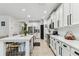 Open kitchen with an extended island, stainless steel appliances, and an archway entrance at 7705 S Sparkman St, Tampa, FL 33616