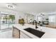 Island sink with a view into an open-concept floor plan leading to a private pool and living room at 7705 S Sparkman St, Tampa, FL 33616