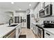 Modern kitchen boasts stainless steel appliances, ample storage, and sleek countertops at 7705 S Sparkman St, Tampa, FL 33616