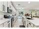 Bright kitchen with a center island, stainless appliances, and a view of the private pool at 7705 S Sparkman St, Tampa, FL 33616