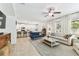 Open living space features a ceiling fan and seamlessly connects to the modern kitchen at 7705 S Sparkman St, Tampa, FL 33616