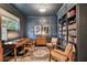Office space with wainscoting, built-in shelving, wood furniture, and a patterned rug at 7705 S Sparkman St, Tampa, FL 33616