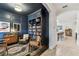 Office with wainscoting, a library, and an entryway into the kitchen and dining area at 7705 S Sparkman St, Tampa, FL 33616