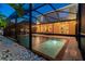 Screened-in pool featuring a spa and an outdoor dining area with string lights above at 7705 S Sparkman St, Tampa, FL 33616