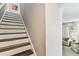Wooden staircase with white risers leading upstairs, adding a touch of elegance at 7705 S Sparkman St, Tampa, FL 33616
