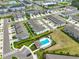 Aerial view of the community showcasing a pool, playground, and well-maintained townhomes in a desirable location at 7709 Imagination Pl, Wesley Chapel, FL 33545