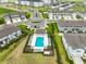 Community aerial view featuring a pool, clubhouse, and residences in a Primary-planned development at 7709 Imagination Pl, Wesley Chapel, FL 33545