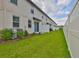 Private backyard with green grass and white fence, perfect for outdoor entertaining and relaxing at 7709 Imagination Pl, Wesley Chapel, FL 33545