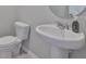Clean and modern powder room features a pedestal sink and efficient toilet at 7709 Imagination Pl, Wesley Chapel, FL 33545