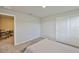 Well-lit bedroom includes a bed and closet with an adjacent office space visible through doorway at 7709 Imagination Pl, Wesley Chapel, FL 33545