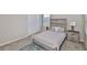 Comfortable bedroom featuring a bed with decorative pillows, nightstand, and large closet at 7709 Imagination Pl, Wesley Chapel, FL 33545