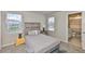 Comfortable bedroom features a bed, nightstand, and views of the neighborhood through the windows at 7709 Imagination Pl, Wesley Chapel, FL 33545