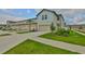 Charming townhome featuring a two-car garage, lush landscaping, and inviting curb appeal in a serene community at 7709 Imagination Pl, Wesley Chapel, FL 33545