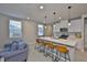 Contemporary kitchen featuring an island with seating, white cabinets, and stainless appliances at 7709 Imagination Pl, Wesley Chapel, FL 33545