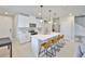 Modern kitchen featuring white cabinets, stainless steel appliances, and a large island with seating at 7709 Imagination Pl, Wesley Chapel, FL 33545